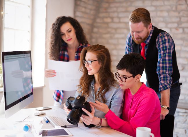 Picture of young attractive architects discussing in office