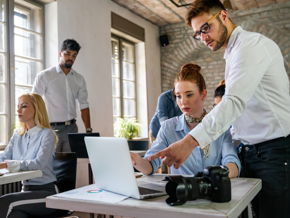 Professional web designers. Portrait of creative designer team smiling while working together in the modern office. Creative agency